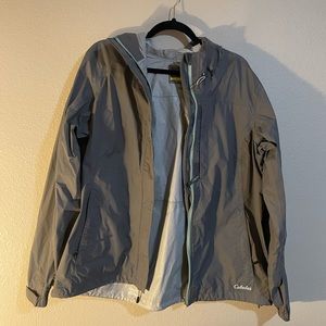 Cabela’s women’s rain jacket, size XL, Pistachio colored zipper trim.